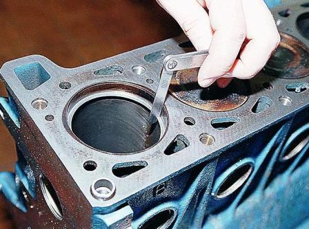 Установив кольцо в цилиндр, набором щупов проверяем зазор в его замке. 