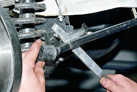 Монтажной лопаткой отжимаем конец штанги и ставим новую подушку