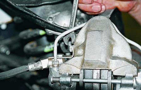 Ключом «на 10» отворачиваем болт крепления скобы