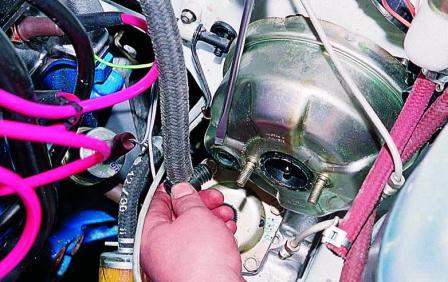 Осторожно поддев отверткой, вынимаем штуцер вакуумного шланга 